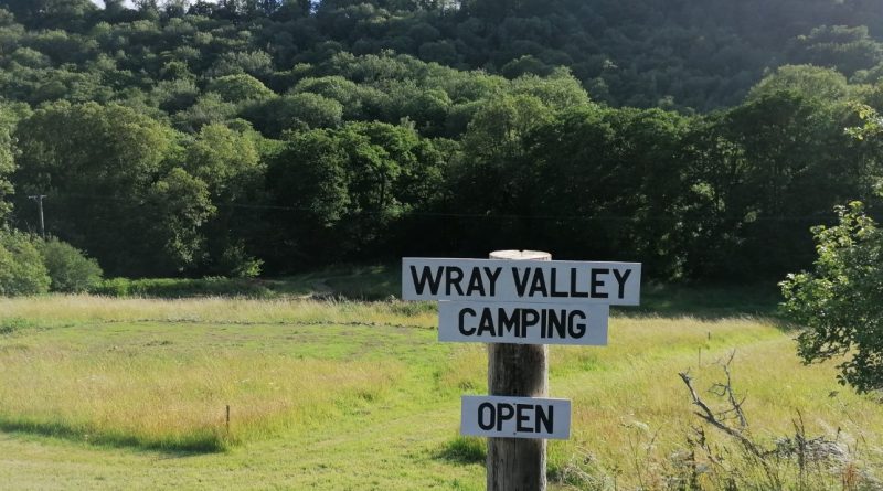 Wray Valley Campsite sign - open for business, view of camping field