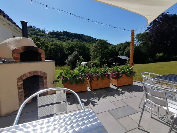 Relax on the patio by the pizza oven. Conveniently located just outside the bedrooms in the B&B accommodation