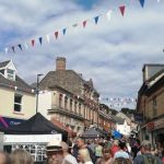 Fore St , Bovey Tracey filled with street market stalls and people