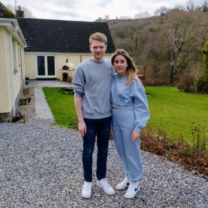 A young couple standing in the carpark of our B&B