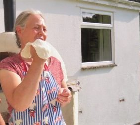 Michelle tossing pizza dough