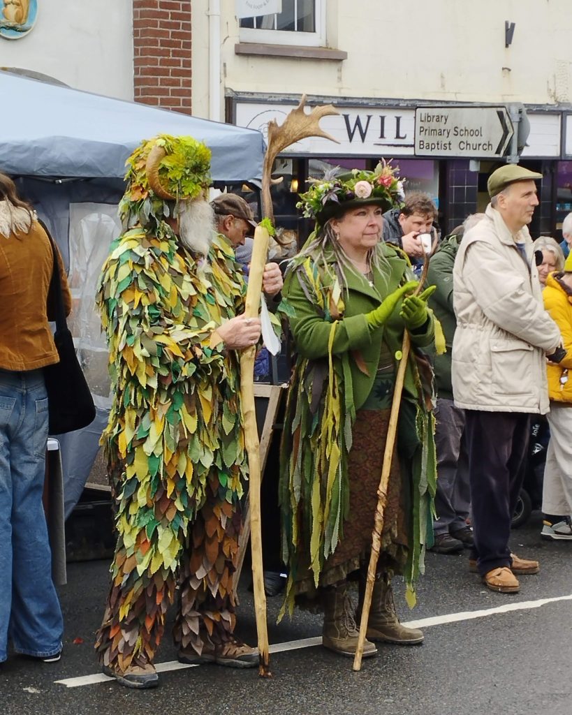 Traditional May Day characters - Morris man and woman dressed in Green with Staff