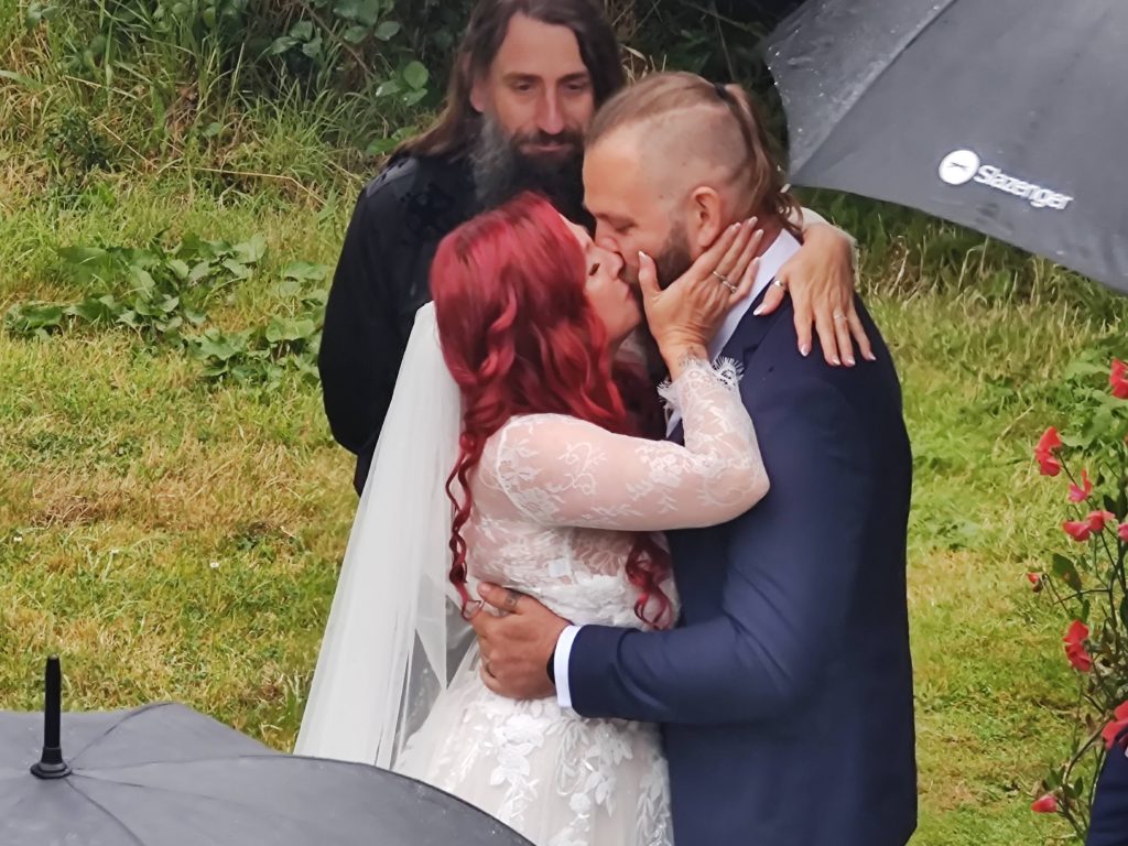 Bex and John kissing at the end of their belssing.  